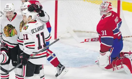  ?? ALLEN MCINNIS/MONTREAL GAZETTE ?? From left, Chicago’s Garrett Ross, Kyle Baun and Andrew Desjardins celebrate after a goal against Canadiens’ Carey Price on Friday at the Bell Centre. The Blackhawks trounced Montreal 5-1.