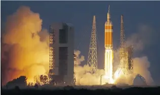  ?? CHRIS O’MEARA/ THE ASSOCIATED PRESS ?? NASA’s Orion capsule, atop a United Launch Alliance Delta 4- Heavy rocket, lifts off from the Cape Canaveral Air Force Station on Friday. It circled the Earth twice in a 4.5- hour mission.