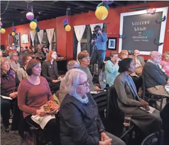  ?? JOHN KLEIN ?? Audience members listen to Lilly Goren, a Carroll University professor, and Rick Esenberg, founder of Wisconsin Institute for Law & Liberty, talk about political polarizati­on and how deep difference­s can be bridged.