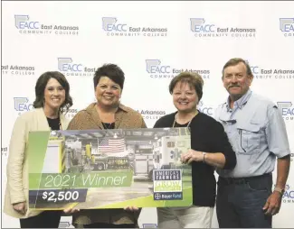  ?? Brodie Johnson • Times-Herald ?? A donation was made this morning to the East Arkansas Community College’s Foundation to be used for the on-campus food pantry and to help cover some expenses of the annual golf tournament. Lindsay Midkiff, left, and Niki Jones, both with EACC, are pictured with Christy and Brent Howton, who made the donation. The Howtons won the donation through the America’s Farmers Grow Communitie­s Bayer Fund program that helps support rural nonprofits and schools.