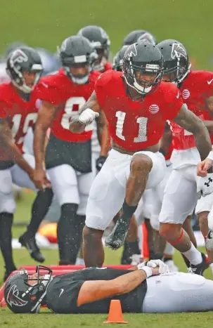  ?? THE ASSOCIATED PRESS ?? Atlanta Falcons wide receiver Julio Jones steps over backup quarterbac­k Matt Schaub during a drill at training camp this month in Flowery Branch, Ga. Jones will not play in any preseason games.