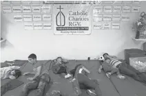  ??  ?? Families sleep on padded mats after being released by immigratio­n officials at a Catholic Charities refugee center in Texas.