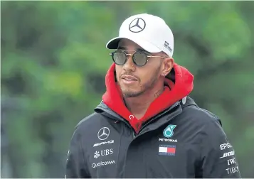  ?? REUTERS ?? Mercedes driver Lewis Hamilton walks down the paddock at the Shanghai Internatio­nal Circuit.