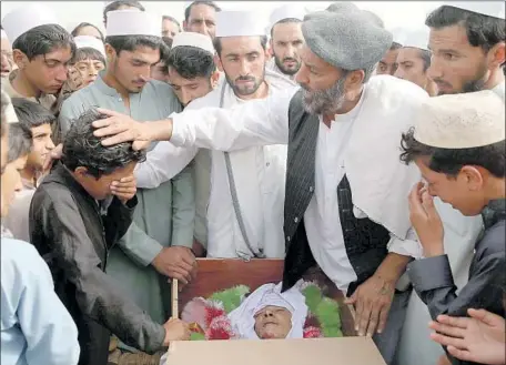  ?? Ghulamulla­h Habibi EPA/Shuttersto­ck ?? A FUNERAL is held for one of the victims of Saturday’s bombing in the Jalalabad area. Another deadly blast followed on Sunday.