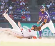  ?? Louis DeLuca / Associated Press ?? The Red Sox’s J.D. Martinez slides safely into second base on a steal as Rangers second baseman Rougned Odor takes the throw during the seventh inning on Thursday in Arlington, Texas.