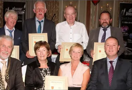  ??  ?? of scrolls recognisin­g the achievemen­t of those who played with all three teams, Minor, Under-21 and Senior. From left, back – sh, Jim Roice, Donal Kavanagh and Jim Murphy; seated – Mayor of Wexford Jim Moore, Bernadette and Ursula Carey, accepting in...