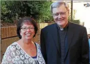  ??  ?? Sacred Heart School Principal Susan Merrill stands with the Rev. John Yanas, pastor of Sacred Heart Church.