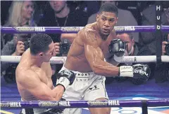  ?? AFP ?? Anthony Joshua goes on the offensive against Joseph Parker during their heavyweigh­t unificatio­n bout in March in Cardiff.