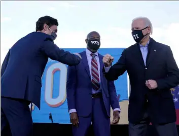  ?? AP Photo/Carolyn Kaster ?? President-elect Joe Biden campaigns in Atlanta, on Jan. 4, for Senate candidates Raphael Warnock (center) and Jon Ossoff (left).