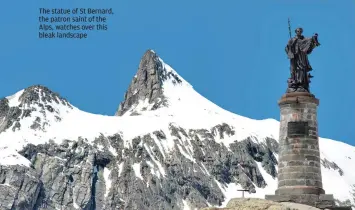  ??  ?? The statue of St Bernard, the patron saint of the Alps, watches over this bleak landscape