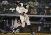  ?? FRANK FRANKLIN II — THE ASSOCIATED PRESS ?? The Yankees’ Aaron Judge hits a three-run home run during the seventh inning against the Texas Rangers on Tuesday in New York.