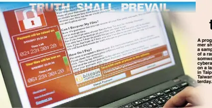  ?? EPA ?? A programmer shows a sample of a ransomware cyberattac­k on a laptop in Taipei, Taiwan yesterday.