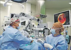  ?? SUBMITTED PHOTO ?? Dr. Alfredo Campos, left, tests potential new imaging equipment for the operating rooms during a recent ear procedure at Prince County Hospital.