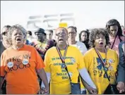  ??  ?? MARCHERS Marcia McMilan Edwards, left, Helen Brooks and Ruth Anthony lead the demonstrat­ion.