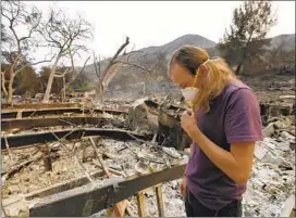  ?? Francine Orr ?? GARET ANZALONE surveys his grandmothe­r’s Westlake Village property. Fire officials expect the number of structures lost to go up as teams assess damage.
