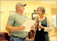  ?? LYNN KUTTER ENTERPRISE-LEADER ?? Jerry Coyle visits with Becky Purcell, pastor of First Presbyteri­an Church in Prairie Grove at Prairie Grove Senior Activity and Wellness Center. Coyle’s company is proposing to build a housing developmen­t for residents 55 years and older.