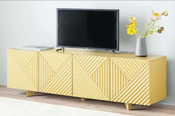  ?? WEST ELM ?? Designer Rosanna Ceravolo’s carved console for West Elm features a sophistica­ted yellow hue and showcases the lines and profiles of Deco style, one of this fall’s hottest trends.
