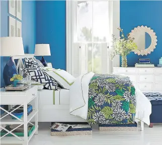  ?? PHOTO COURTESY OF POTTERY BARN ?? Crisp white sheets with a touch of green are a soothing match for the patterned coverlet with its stylized floral design which, in turn, sports colours that contrast nicely with the bright blue walls in this room. Night-table lamps provide convenient...