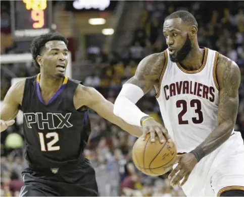  ??  ?? CLEVELAND: Cleveland Cavaliers’ LeBron James (23) passes against Phoenix Suns’ TJ Warren (12) in the second half of an NBA basketball game. —AP