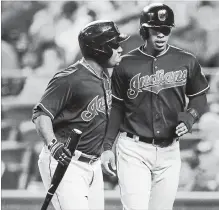  ?? ASSOCIATED PRESS FILE PHOTO ?? Cleveland Indians' Francisco Lindor, right, celebrates with teammate Jose Ramirez after scoring on a sacrifice fly in Kansas City on Sept. 27.
