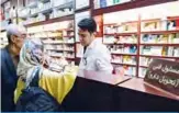  ??  ?? TEHRAN: Photo shows an Iranian woman shopping at a pharmacy at the Nikan hospital in the Iranian capital Tehran. —AFP