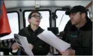  ?? AP PHOTO/SETH WENIG ?? In this April 29 photo, Melinda Hart, president of the Hart Island Project, left, explains to drone operator Daniel Herbert what kind of visuals she is looking for while anchored off the coast of Hart Island in New York. Hunt, the creator of the Hart...