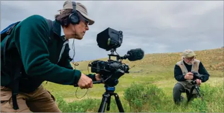  ?? Photos courtesy Overtime Studios ?? Filmmaker George Tsougriani­s (at left) focuses his camera on photograph­er James R. Page during the shooting of a scene for the documentar­y Wild Prairie Man. (Below) Tsougriani­s in Grasslands National Park to shoot winter scene.