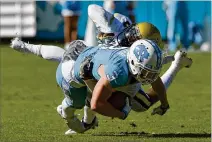  ?? GRANT HALVERSON / GETTY IMAGES ?? Georgia Tech cornerback Step Durham brings down NC State’s Ryan Switzer during a 2016 game. Durham will be getting a tryout with the Tennessee Titans in two weekends. Durham started 23 games in his Yellow Jackets career.