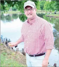  ?? FILE PHOTO ?? John Baker, a Little Rock attorney, holds a stone that he thinks is good for skipping. Baker, who grew up skipping rocks and enjoys the activity with his children, as well as his brother, created the Great Southern Stone-Skipping Championsh­ip. The...