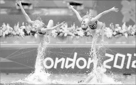  ?? — Photo by The Associated Press. ?? Russian synchroniz­ed swimmers are thrown up in the air during the women’s team synchroniz­ed swimming technical routine at the Aquatics Centre in the Olympic Park Thursday.