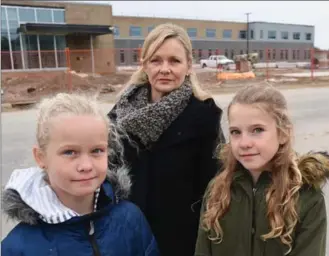  ?? PETER LEE, RECORD STAFF ?? Amy Dean and her daughters Clancy, 10, left, and Delaney, 12, in front of Groh Public School, which will open in southwest Kitchener with French immersion for Grade 1 students only.