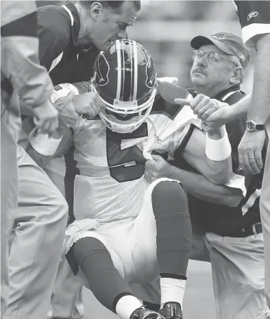  ?? DONALD MIRALLE / GETTY IMAGES FILES ?? Former Buffalo Bills quarterbac­k Trent Edwards is helped up after taking a hard tackle and suffering a concussion in a game in 2008. The long-term brain health of football players was back in the headlines after a study, released last month, found...