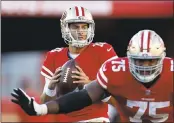  ??  ?? The 49ers’ Jimmy Garoppolo looks for a receiver downfield. Garoppolo passed for 381 yards and a touchdown in his first start at Levi’s Stadium. GM John Lynch, left, was thrilled after the win.