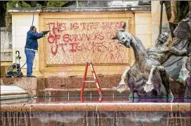  ?? JAY JANNER / AMERICAN-STATESMAN ?? Graffiti is removed from the Littlefiel­d Fountain at the University of Texas South Mall on Thursday. UT police will be increasing their patrols on campus in response to a recent spate of such graffiti incidents, the university says.