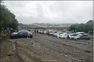  ?? NATIONAL PARK SERVICE VIA AP ?? Left: Cars are stuck in mud and debris from flash flooding Aug. 5 at The Inn at Death Valley in Death Valley National Park.