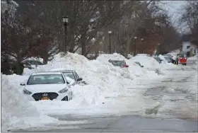  ?? JEFFREY T. BARNES/THE ASSOCIATED PRESS, FILE ?? In a Dec. 29, 2022, photo, snow-covered cars line a side street in Buffalo, N.Y., a few days after a winter storm rolled through the region.