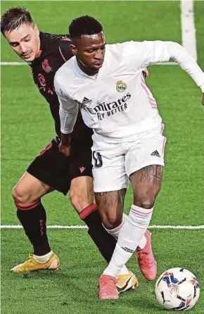  ?? AFP PIC ?? Real Sociedad’s Andoni Gorosabel (left) challenges Real Madrid’s Vinicius Junior during their La Liga match on Monday.