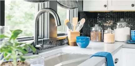  ?? HGTV/SCRIPPS NETWORKS, LLC. ?? Black and white is a great choice for a kitchen colour scheme because any accent colour can blend in well. In this kitchen designed by Brian Patrick Flynn for the HGTV Urban Oasis 2016 giveaway, bright blue dishes and towels liven up the space.