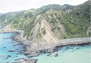  ?? ROYAL NEW ZEALAND DEFENCE FORCE VIA REUTERS ?? Landslides block State Highway One near Kaikoura on the upper east coast of New Zealand’s South Island following an earthquake on November 14, 2016. Tour operators and hotels in Kaikoura say they are struggling to survive as blocked roads keep would-be...