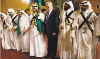  ?? EVAN VUCCI/THE ASSOCIATED PRESS ?? President Donald Trump holds a sword and dances with traditiona­l dancers May 20 during a welcome ceremony at Murabba Palace in Riyadh. Trump’s trip did divide the media’s attention, which for the White House might have been a welcome change.