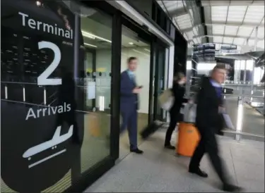  ?? KIRSTY WIGGLESWOR­TH — THE ASSOCIATED PRESS FILE ?? In this file photo, people pass an arrivals sign at the new Heathrow Airport Terminal 2 in London. Airfares to Europe this summer are expected to be slightly higher than last year, blame the rise in jet fuel prices, but that’s an overall, average...