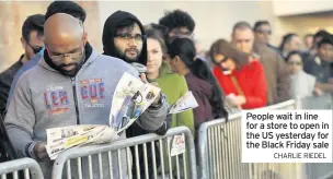  ?? CHARLIE RIEDEL ?? People wait in line for a store to open in the US yesterday for the Black Friday sale