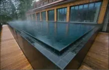  ??  ?? A heated outdoor spa pool sits on decking outside the Schloss Elmau hotel.