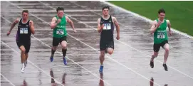  ??  ?? Athletes brave the torrential rain during the 100m in Santry on Saturday