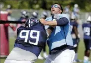  ?? MARK HUMPHREY — THE ASSOCIATED PRESS ?? Tennessee Titans head coach Mike Vrabel, right, runs a drill against defensive tackle Jurrell Casey (99) during NFL football training camp Thursday in Nashville, Tenn.