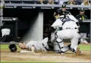  ?? FRANK FRANKLIN II — THE ASSOCIATED PRESS ?? Yankees catcher Austin Romine, right, tags out the Athletics’ Adam Rosales in the eighth inning Friday.