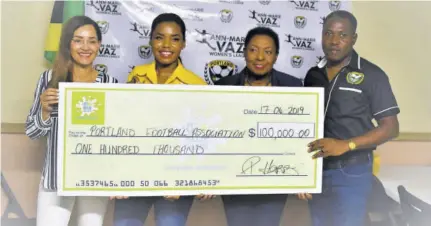  ?? (Photos: Everard Owen) ?? (From left) Member of Parliament Ann-marie Vaz, 876 Spring Water Brand Manager Petrene Harris, Minister of Sport Olivia Grange, and Portland Football Associatio­n President Raymond Anderson display the symbolic sponsorshi­p cheque valued at $100,000.