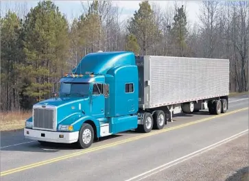  ?? Photograph­s by Office of Secure Transporta­tion, National Nuclear Security Administra­tion ?? THE TRACTOR-TRAILERS the government uses to haul nuclear weapons, components, plutonium and highly enriched uranium on the nation’s highways each day look much like commercial Peterbilt 18-wheelers.