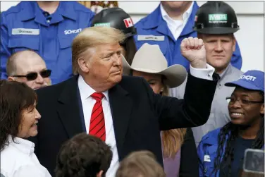  ?? ALEX BRANDON — THE ASSOCIATED PRESS ?? President Donald Trump pumps his fist after signing a new North American trade agreement with Canada and Mexico, during an event at the White House, Wednesday.