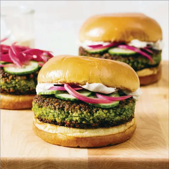  ?? DANIEL J. VAN ACKERE — AMERICA’S TEST KITCHEN VIA AP ?? Falafel burgers with tahini-yogurt sauce.